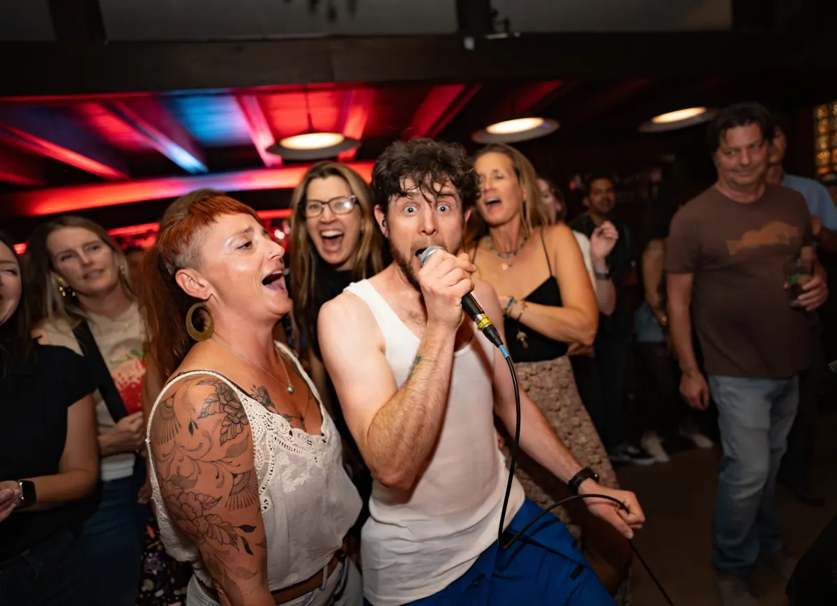 Midlife on Mars singer performing in the middle of a lively crowd